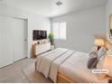 Cozy bedroom with a queen bed, neutral tones, and sliding door closet at 2125 Stone Well Rd, North Las Vegas, NV 89031
