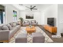 Bright living room featuring modern decor, a plush sofa, and a stylish rug, perfect for relaxing and entertaining guests at 2125 Stone Well Rd, North Las Vegas, NV 89031
