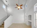 Bright, open living room features soaring ceilings, a modern ceiling fan, and lots of natural light at 2125 Stone Well Rd, North Las Vegas, NV 89031