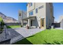 Well-maintained backyard featuring a covered patio, artificial turf, and desert landscaping at 2151 Noble Perch St, Las Vegas, NV 89138