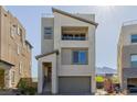Contemporary two-story home with a balcony, neutral stucco, and a two-car garage at 2151 Noble Perch St, Las Vegas, NV 89138