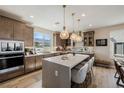 Bright, modern kitchen with stainless steel appliances, quartz countertops, and a large island with seating at 2151 Noble Perch St, Las Vegas, NV 89138