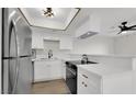 Well-lit kitchen with stainless steel appliances and white cabinets and countertops at 2480 Old Forge Ln # 74, Las Vegas, NV 89121