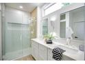 Bright bathroom with double sinks, quartz countertop, modern fixtures, and a glass-enclosed shower at 2561 Terrytown Ave, Henderson, NV 89052