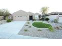 Beautiful one-story home featuring a well-manicured front yard with gravel landscaping, artificial turf, and desert plants at 2623 Red Planet St, Henderson, NV 89044