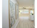 Bright and spacious hallway featuring light wood floors, recessed lighting, and two decorative art pieces at 2623 Red Planet St, Henderson, NV 89044