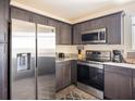 Modern kitchen featuring stainless steel appliances, dark cabinets, and granite countertops at 2629 Mocha Pearl Ct, North Las Vegas, NV 89086