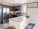 A full kitchen featuring stainless steel appliances, gray cabinets, and an island at 2629 Mocha Pearl Ct, North Las Vegas, NV 89086