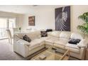 Inviting living room features a comfortable sectional sofa and a glass coffee table at 2629 Mocha Pearl Ct, North Las Vegas, NV 89086
