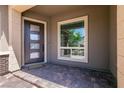 Stylish front entryway with a modern door and brick-paved porch at 2680 Nevada Agave Ln, Las Vegas, NV 89138