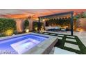 Backyard view showcasing in-ground spa and an outdoor dining area at 2680 Nevada Agave Ln, Las Vegas, NV 89138