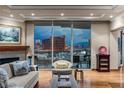 Bright living room boasting a fireplace, hardwood floors, and expansive windows showcasing the city skyline at 2877 Paradise Rd # 2602, Las Vegas, NV 89109