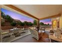 The covered patio offers a relaxing outdoor living space with comfortable seating and a serene ambiance at 2925 Lotus Hill Dr, Las Vegas, NV 89134