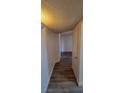Hallway with wood-look vinyl flooring and white walls leading to an adjoining room at 3151 Soaring Gulls Dr # 2058, Las Vegas, NV 89128