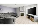 Comfortable living room with a fireplace, plush seating, and neutral colors at 3464 Twilight Star Dr, Las Vegas, NV 89117