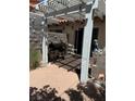 Outdoor patio featuring a white pergola, grill, and concrete pavers, providing a comfortable backyard space at 3464 Twilight Star Dr, Las Vegas, NV 89117