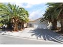 Charming single story home with a two car garage, desert landscaping and mature palm trees at 3646 Billman Ave, Las Vegas, NV 89121