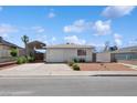 Inviting single-story home with desert landscaping, covered parking, and bright curb appeal at 460 Crestway Rd, Henderson, NV 89015