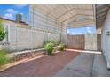Spacious covered parking area with concrete and desert landscaping for low maintenance at 460 Crestway Rd, Henderson, NV 89015