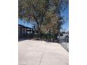 Spacious driveway, covered porch and desert landscaping with mature tree at 4727 Conrad St, Las Vegas, NV 89121