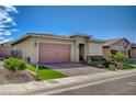 A cozy home with a two-car garage and a neatly landscaped front yard with green turf at 505 Sterling Falls Ave, Henderson, NV 89011
