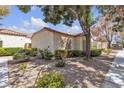 This single-story home boasts a well-kept exterior with lush landscaping and mature shade trees at 5400 Paul Kurtz Way # 105, Las Vegas, NV 89108