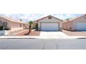 Single-story home featuring a two-car garage and low-maintenance desert landscaping at 5524 La Pelusa St, North Las Vegas, NV 89031