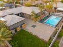Expansive backyard featuring a sparkling pool, mature trees, and sleek modern design elements at 6110 Pebble Glen Ct, Las Vegas, NV 89149