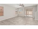 Bright living room with tile flooring, large windows, and sliding glass doors leading to the backyard at 6443 Burlap Ct, Las Vegas, NV 89122