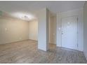 Open concept living room featuring updated floors and a minimalist modern design aesthetic at 725 N Royal Crest Cir # 228, Las Vegas, NV 89169