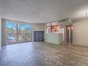 Bright living room with wood floors, a large window, and an adjacent kitchen at 725 N Royal Crest Cir # 228, Las Vegas, NV 89169