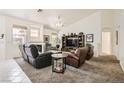 Spacious living room boasts a cozy fireplace, large windows, and comfortable seating at 7515 Splashing Rock Dr, Las Vegas, NV 89131