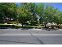 Serene street view with mature trees in a well-maintained neighborhood at 7727 Widewing Dr, North Las Vegas, NV 89084
