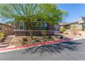 Charming single-story home featuring manicured landscaping, mature trees, and a brick driveway at 8 Via Tiberina, Las Vegas, NV 89011