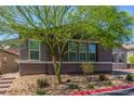 Charming single-story home featuring manicured landscaping, mature trees, and a brick driveway at 8 Via Tiberina, Las Vegas, NV 89011