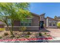 Charming single-story home featuring manicured landscaping, mature trees, and a brick driveway at 8 Via Tiberina, Las Vegas, NV 89011