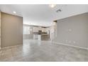 Open-concept living space with tile floors, neutral paint, and ample natural light at 8486 Insignia Ave # 101, Las Vegas, NV 89178