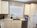 Bright kitchen showcasing stainless steel appliances, granite countertops, modern sink, and white cabinetry at 8534 Insignia Ave # 101, Las Vegas, NV 89178