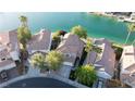 Aerial view of several homes on the water with a blue sky backdrop at 8740 Captains Pl, Las Vegas, NV 89117