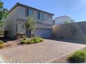 Two story home with brick paver driveway and walkway at 8793 Candelabra Ct, Las Vegas, NV 89148