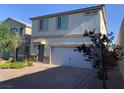 Charming two-story home with a two-car garage, stone accents, and a well-maintained front yard at 8793 Candelabra Ct, Las Vegas, NV 89148