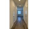 Hallway with wood floors and white doors at 8793 Candelabra Ct, Las Vegas, NV 89148
