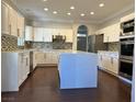 Modern kitchen showcases a large island, stainless appliances, and ample storage space at 8931 Lansberry Ct, Las Vegas, NV 89147