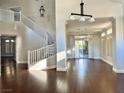 Open-concept living room with a spiral staircase, hardwood floors and backyard access at 8931 Lansberry Ct, Las Vegas, NV 89147