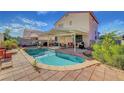 Backyard featuring a private pool, a covered patio area perfect for outdoor dining, and mature landscaping at 1025 Clover Tip Ct, Las Vegas, NV 89123