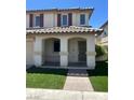 Charming two-story home with a covered porch and low-maintenance artificial turf in the front yard at 1069 Coronado Peak Ave, Las Vegas, NV 89183