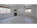 Bright living room with tile flooring, fireplace, ceiling fan, and dual windows at 1069 Coronado Peak Ave, Las Vegas, NV 89183