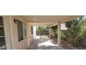 A covered patio area, providing a shady spot with desert landscaping at 1325 Fiesta Grande Ct, North Las Vegas, NV 89031