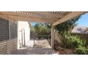 A covered patio area leads to a fenced yard, offering a blend of shade and outdoor space at 1325 Fiesta Grande Ct, North Las Vegas, NV 89031
