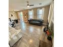 Bright and airy living room with hardwood floors, ceiling fan and plenty of natural light at 1355 Grass Creek Ave # 1, Henderson, NV 89012
